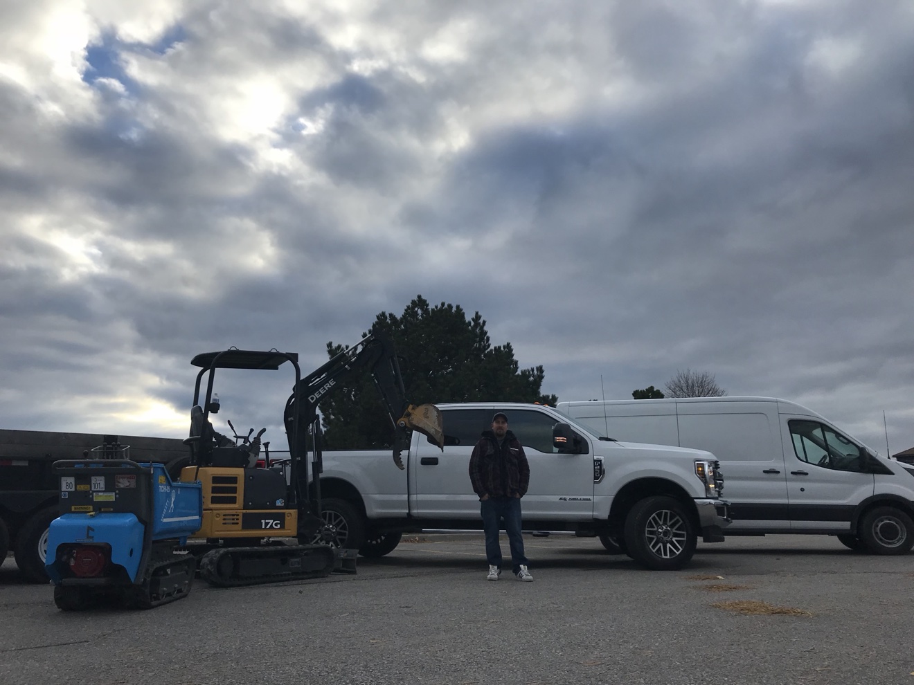 Manulock Construction crew with work trucks and mini excavator in Oshawa