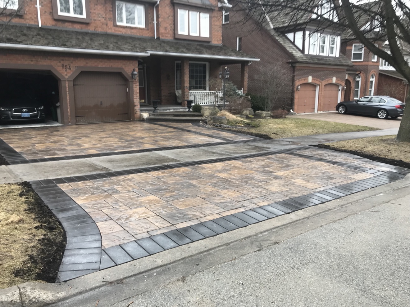 Interlocking paver driveway with dark border installed by Manulock Construction